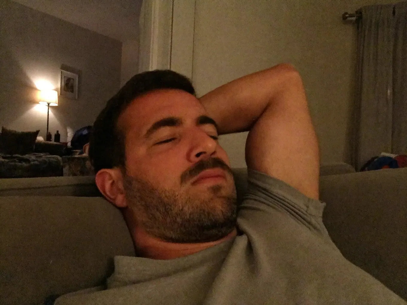 UGC — man slumped, exhausted on couch, evening, no energy
