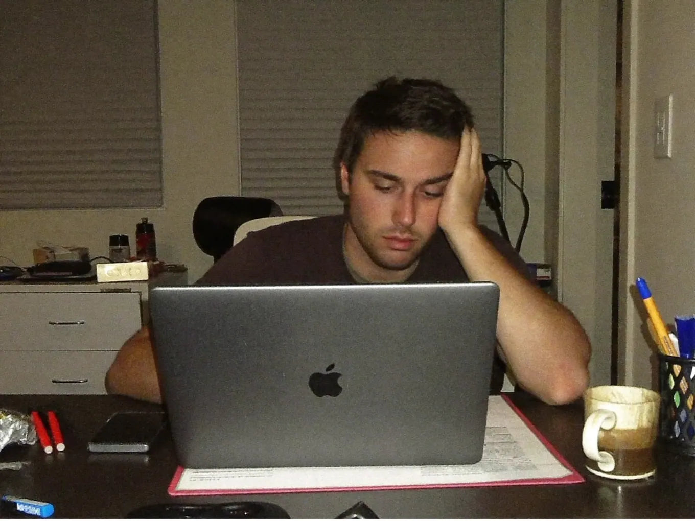 Tired man slumped at his desk in the afternoon