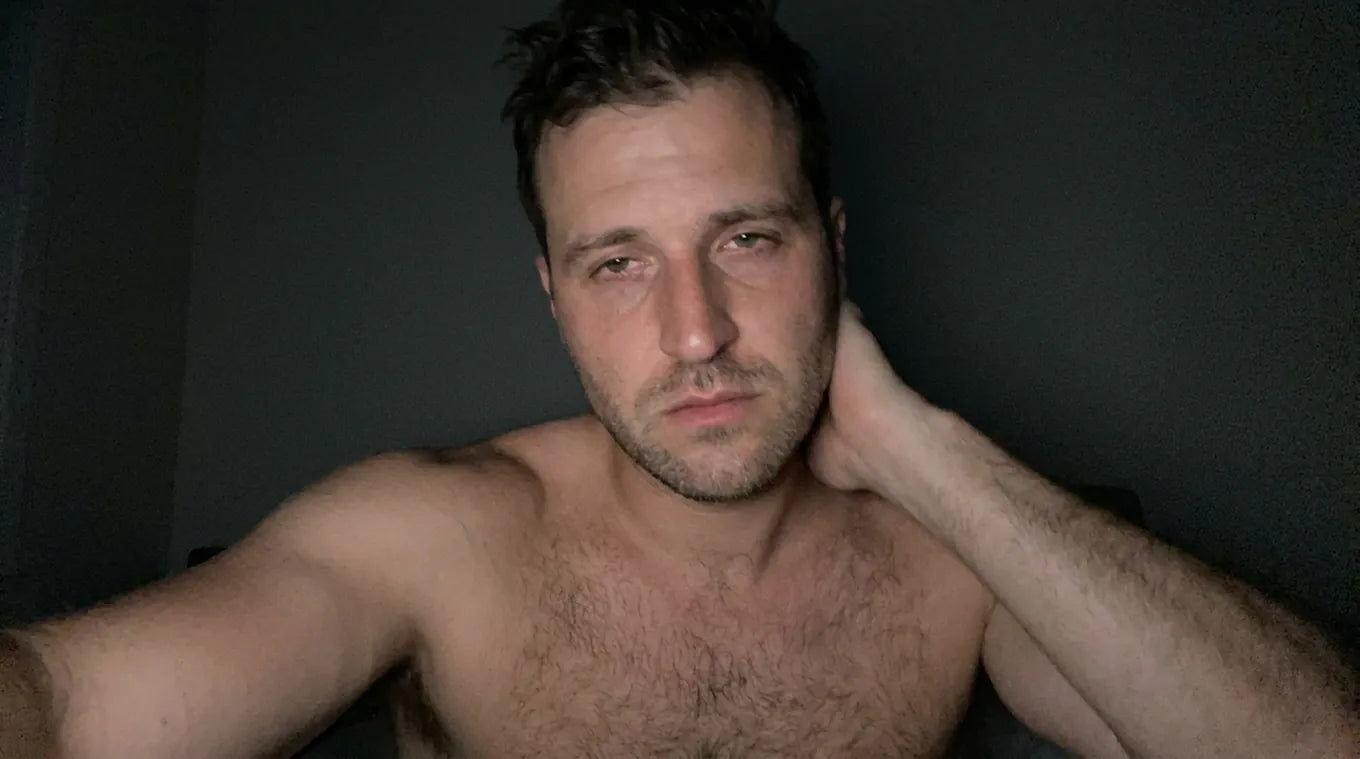 Man sitting on the edge of the bed in the morning, low energy